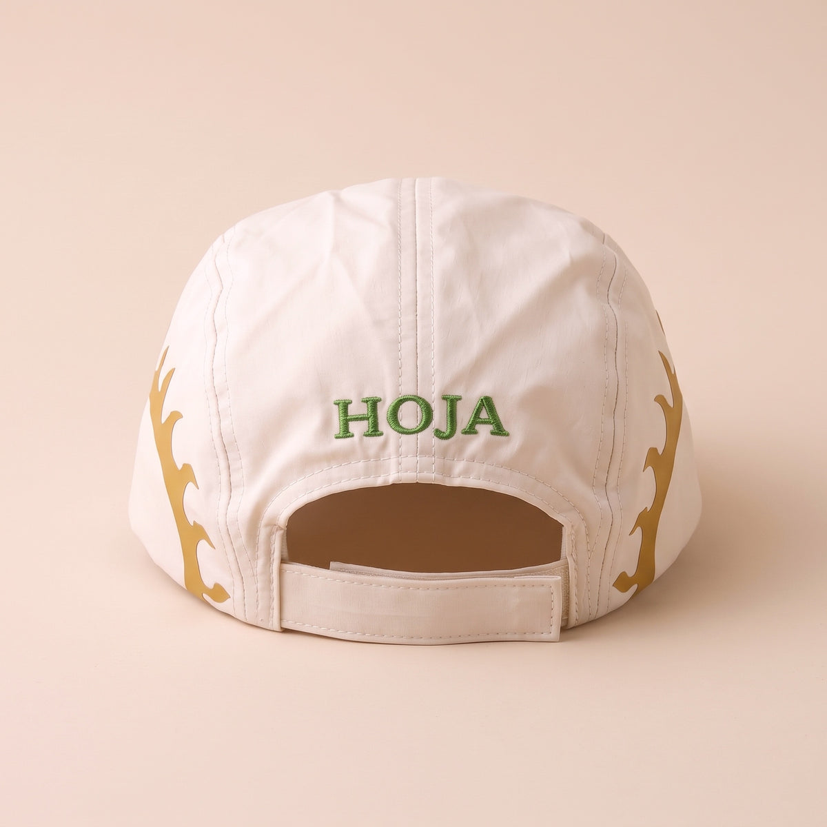 Back of the SOL Cap showing the green embroidered HOJA logo and velcro strap